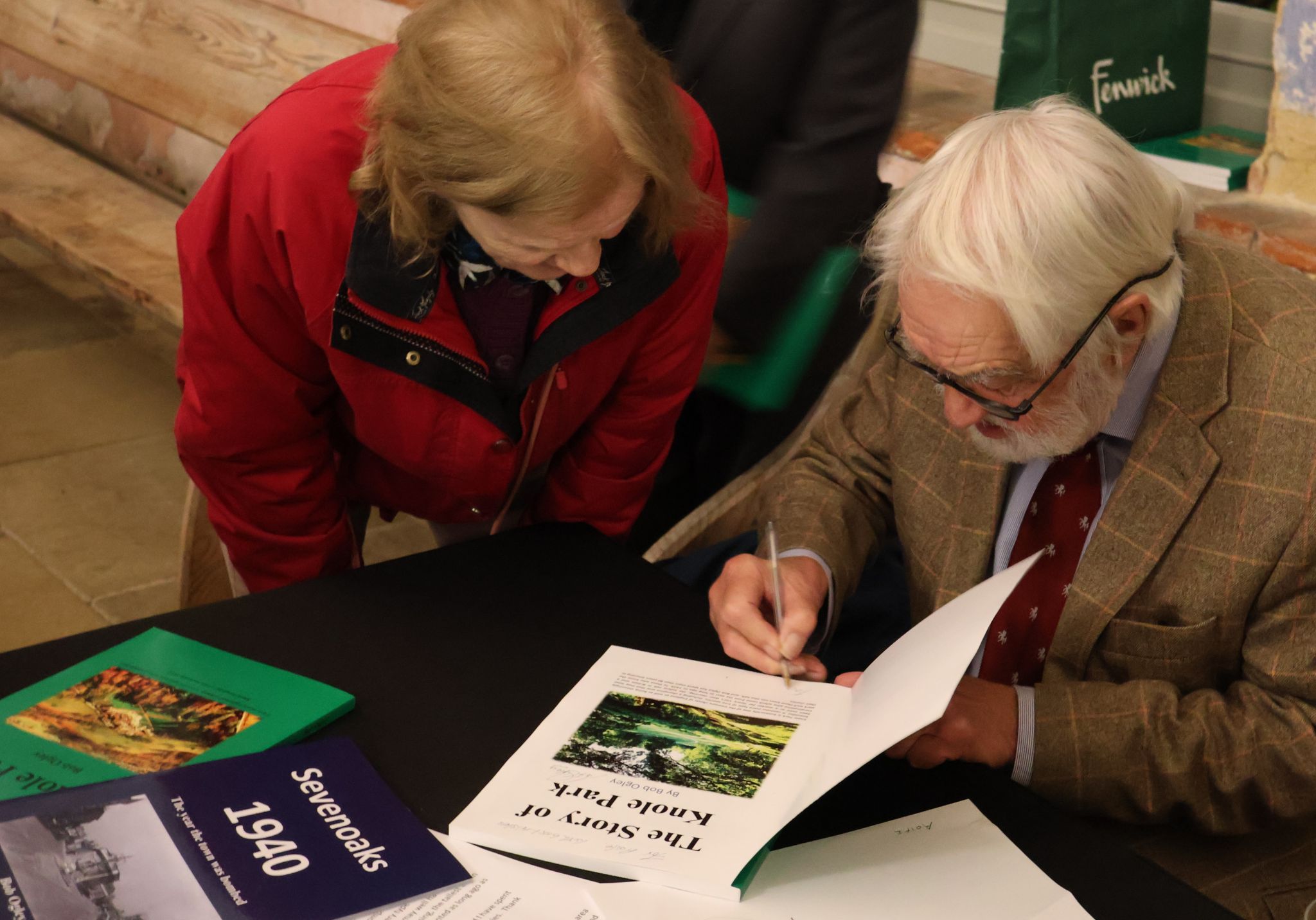 Bob Ogley signs book